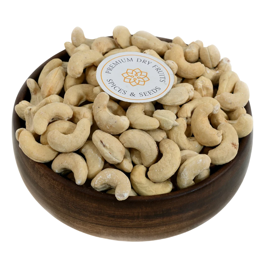 Golden roasted salted cashew nuts in wooden bowl - premium crunchy protein-rich snack