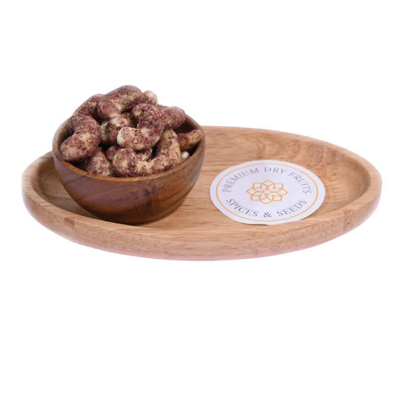 Wooden bowl with dried fruits(Cashew Nuts Rose Petal) on a wooden tray with a visible brand label.