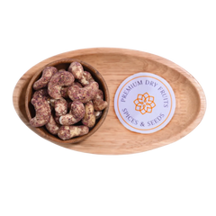 Wooden bowl with Cashew Nuts Rose Petal and a 'Premium Dry Fruits Spices & Seeds' label on a white background