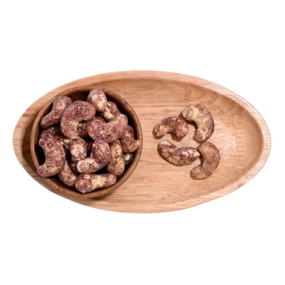 Wooden bowl filled with Cashew Nuts Rose Petal on a wooden tray