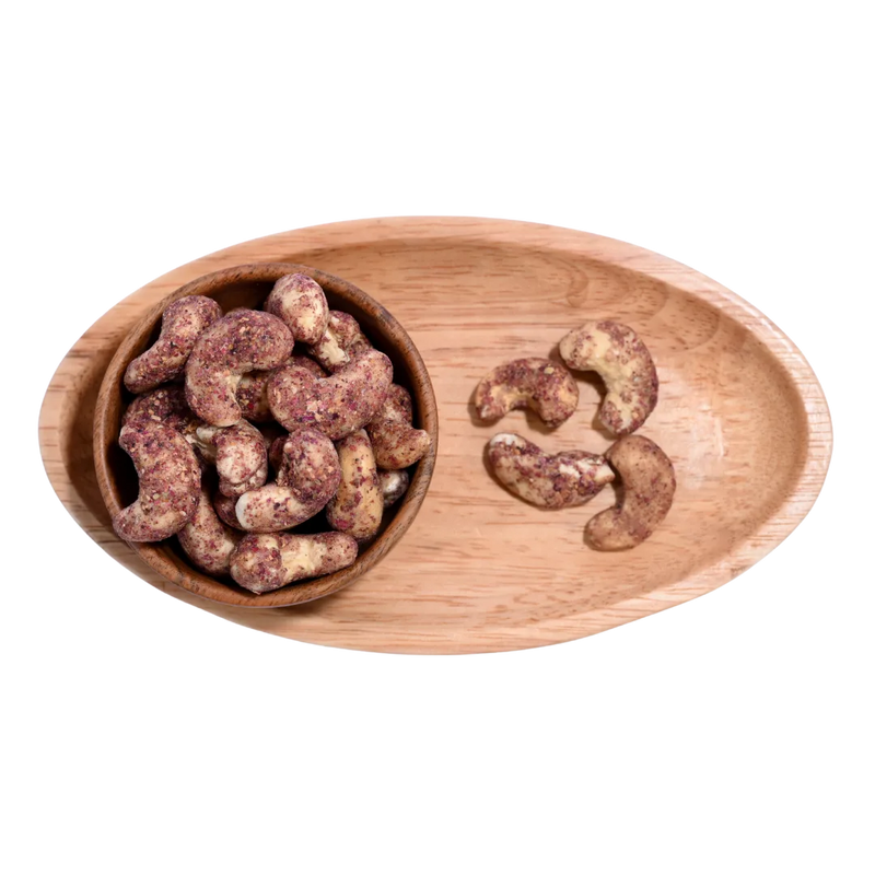 Wooden bowl filled with Cashew Nuts Rose Petal on a wooden tray
