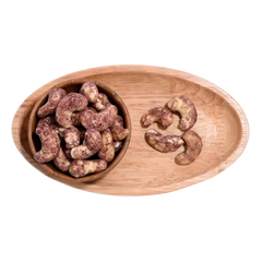 Wooden bowl filled with Cashew Nuts Rose Petal on a wooden tray