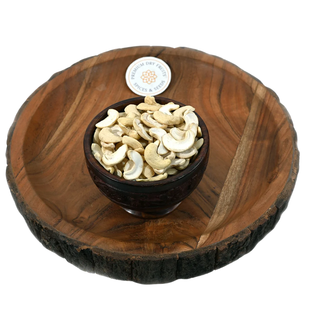 Fresh split cashew kernels displayed in a wooden bowl, buy premium cashews online in Bangalore from House of Rasda, perfect for sweets and snacks.