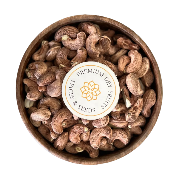 A delicious display of Cashew Nuts Unpeeled and Roasted, perfect for snacking or adding to recipes. Golden and crunchy Cashew Nuts Unpeeled and Roasted are presented in a simple wooden bowl.