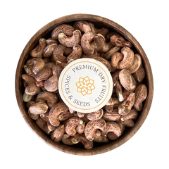 A delicious display of Cashew Nuts Unpeeled and Roasted, perfect for snacking or adding to recipes. Golden and crunchy Cashew Nuts Unpeeled and Roasted are presented in a simple wooden bowl.