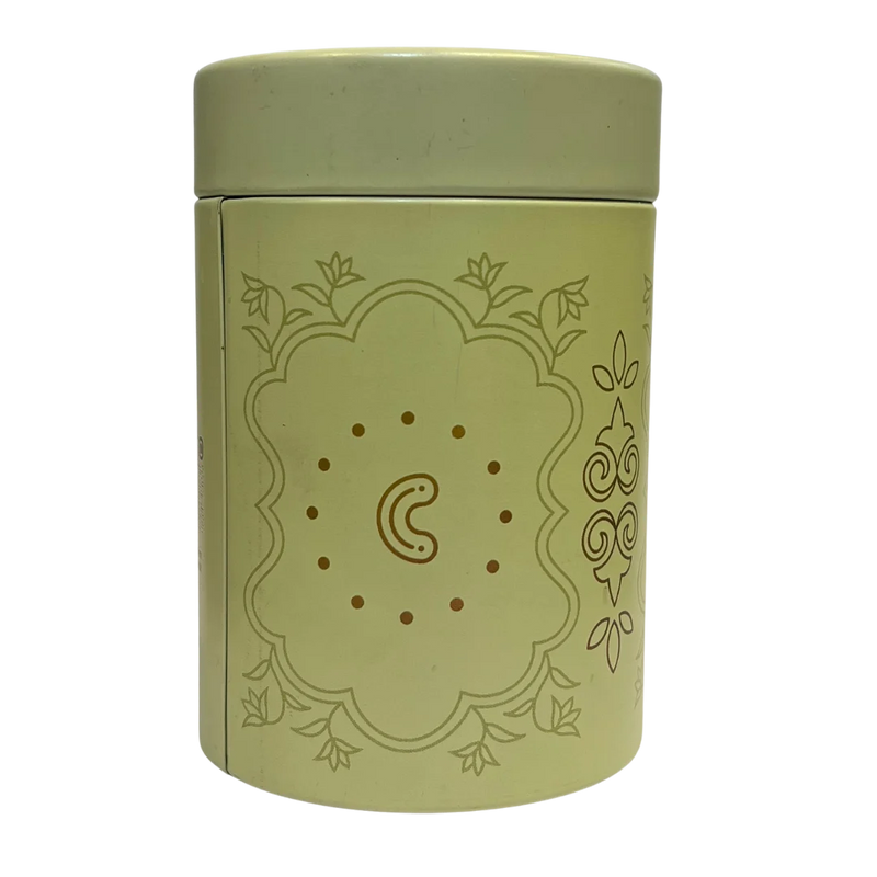 Green cylindrical container with Cashew flavour decorative design on a white background