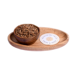 Close-up of charoli seeds, small, light brown, and oval-shaped. A bowl filled with charoli seeds, showing their light brown color and oval shape