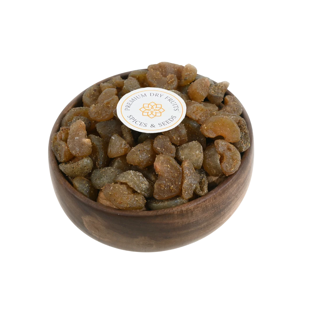 Chatpata Amla Dried Candy in a rustic wooden bowl on a neutral background.