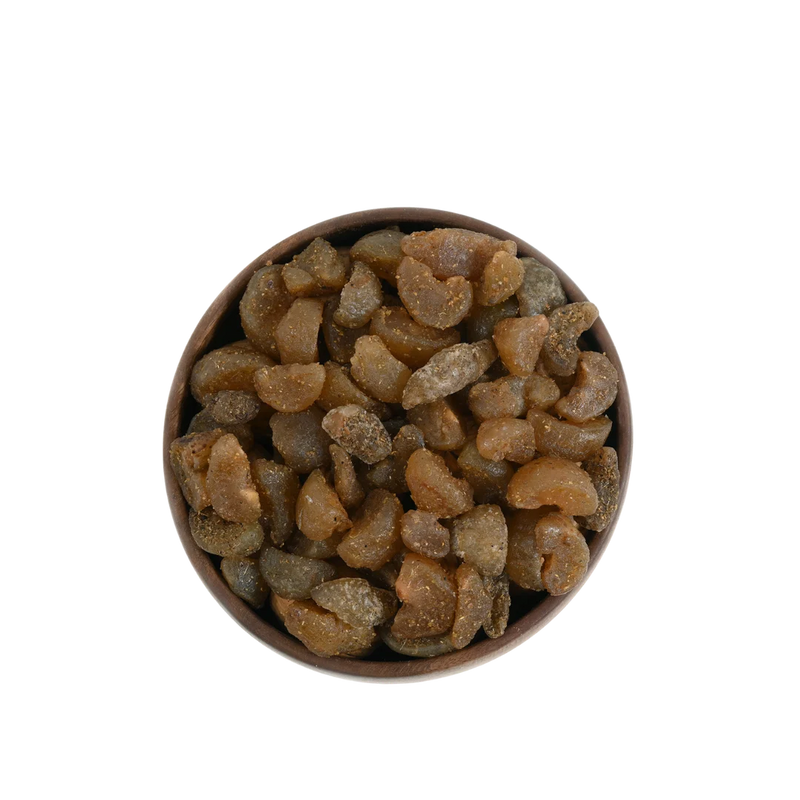 Chatpata Amla Dried Candy with a tangy coating displayed in a handcrafted wooden bowl.