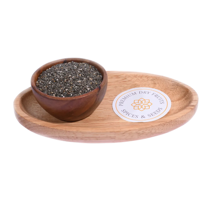 Wooden bowl with chia seeds on a wooden tray with a label, on a white background