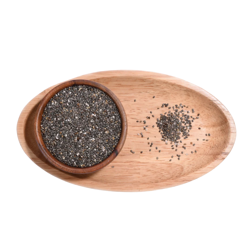 Wooden bowl with chia seeds on a wooden tray