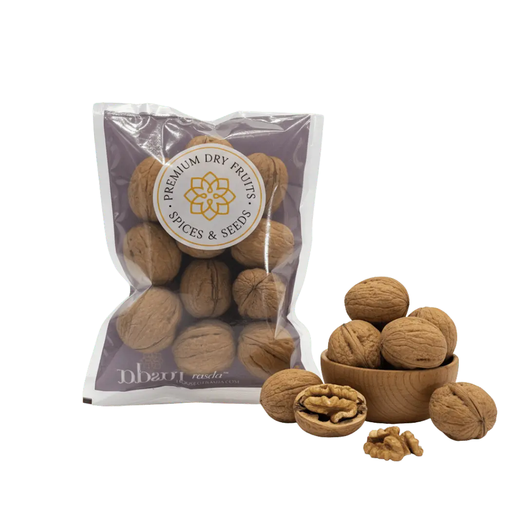 Premium in-shell walnuts (Akhrot) in sealed pack with whole walnuts and kernel shown in wooden bowl.