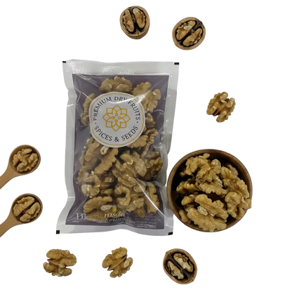 Premium Chilean walnuts (Akhrot) halves pack with wooden bowl and scattered walnut kernels on black background.