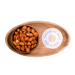 An overhead view of a colorful spread of chilli garlic peanuts, highlighting the red and gold hues of the spices used.