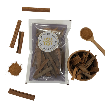 Cinnamon sticks with packaging and a wooden spoon on a white background