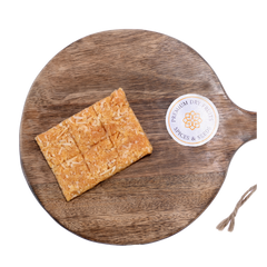 Close-up of golden brown coconut chikki squares – rich in fiber and flavor, made with natural jaggery and shredded coconut.