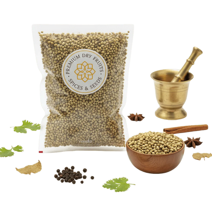 Bag of Coriander Seeds with a bowl of Coriander Seeds, a mortar and pestle, and various spices on a white background.