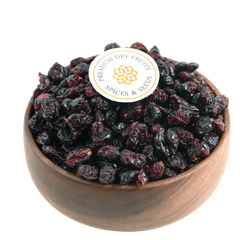 Premium whole dried cranberries in a wooden bowl, showcasing their deep red color and plump texture.