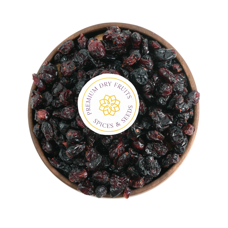 Close-up of glossy dried cranberries arranged in a rustic wooden bowl, highlighting their freshness and shine.