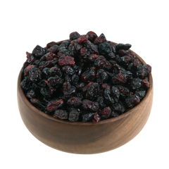 Natural whole dried cranberries beautifully presented in a handcrafted wooden bowl on a neutral background.