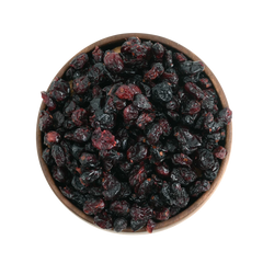Rich red dried cranberries displayed in a round wooden bowl, emphasizing their premium quality and vibrant look.