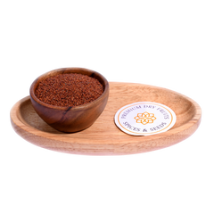 A bowl filled with cress seeds, tiny and round, with a reddish-brown.