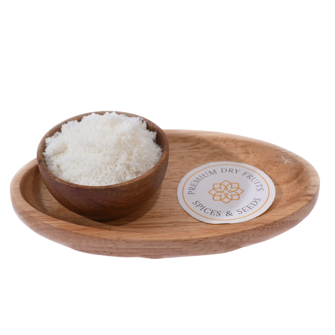 Fine white Desiccated Coconut Powder Nariyal Burada in a wooden bowl, showcasing its soft and fluffy texture.