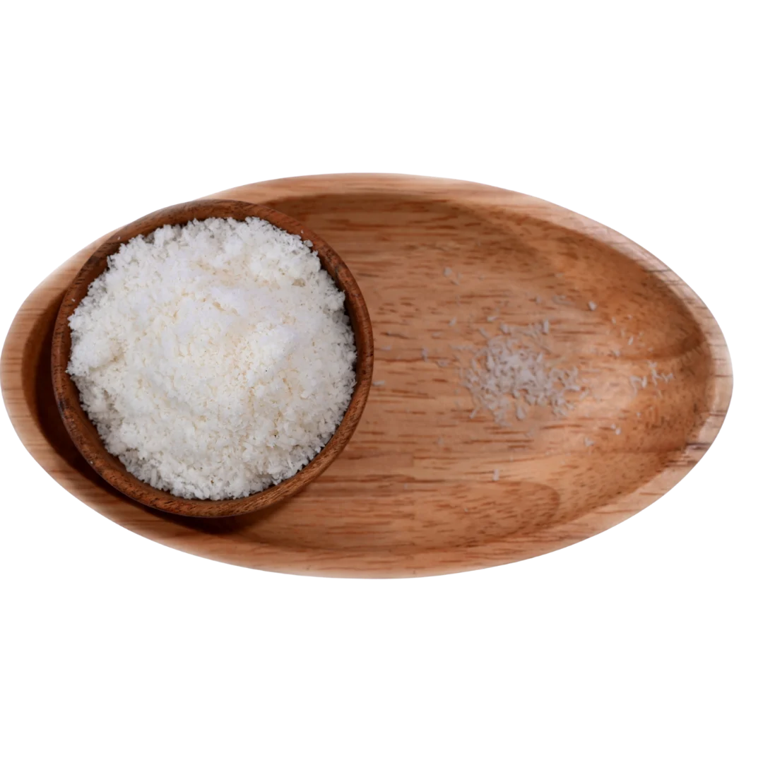 Finely shredded Desiccated Coconut Powder Nariyal Burada in a wooden bowl, showing its light, fluffy, and natural form.