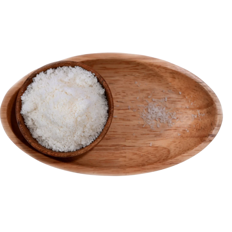 Finely shredded Desiccated Coconut Powder Nariyal Burada in a wooden bowl, showing its light, fluffy, and natural form.