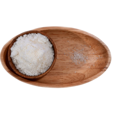 Finely shredded Desiccated Coconut Powder Nariyal Burada in a wooden bowl, showing its light, fluffy, and natural form.