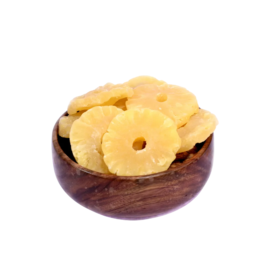 Dried pineapple slices in a wooden bowl on a white background
