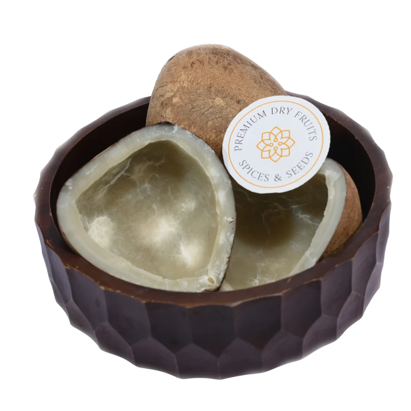Natural Dry Coconut Halves / Copra displayed in a wooden bowl, showcasing their white flesh and brown shell.