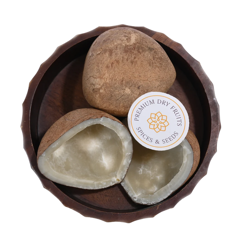 Close-up of Dry Coconut Halves / Copra, highlighting the firm coconut meat and textured outer shell.