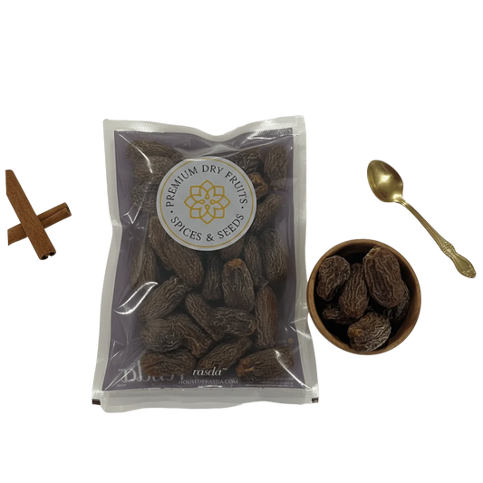 Packaged Black Dry Dates with a bowl and spoon on a white background