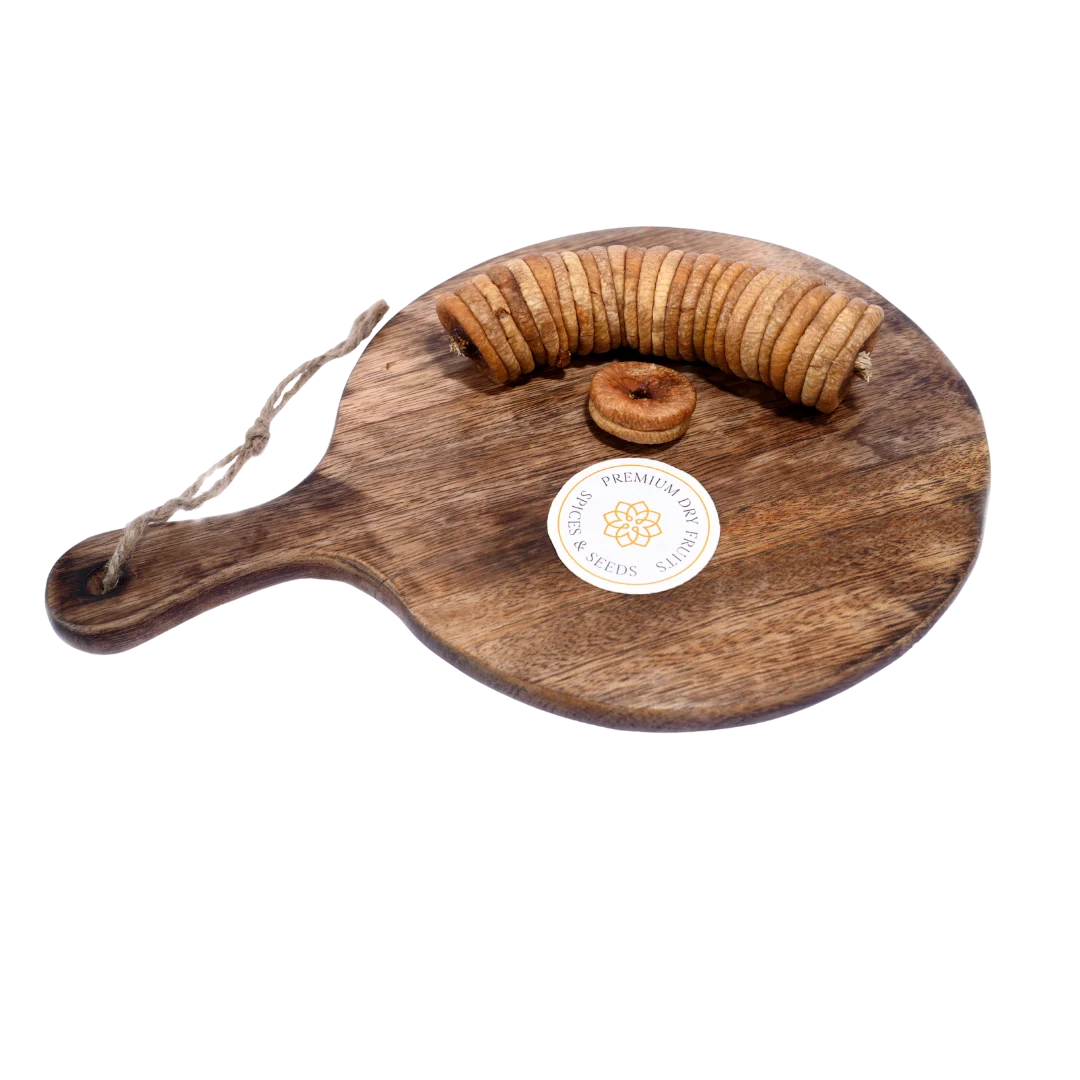 Close-up of Dry Figs Choice Anjeer on a wooden surface, showcasing freshness and detailed wrinkles.