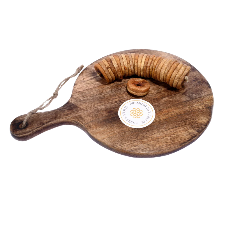 Close-up of Dry Figs Choice Anjeer on a wooden surface, showcasing freshness and detailed wrinkles.