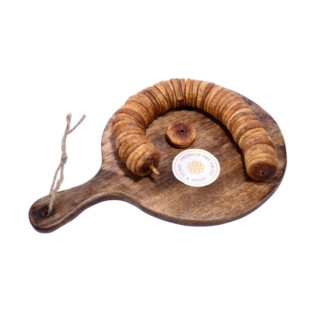 Dry Figs Choice Anjeer placed on a wooden surface, highlighting their natural brown tone and smooth texture.