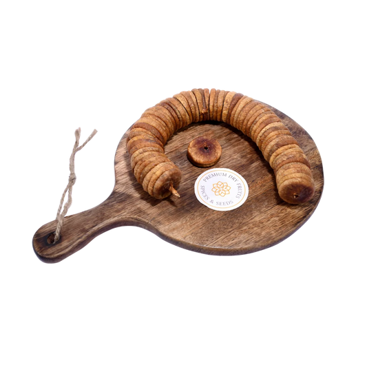 Dry Figs Choice Anjeer placed on a wooden surface, highlighting their natural brown tone and smooth texture.