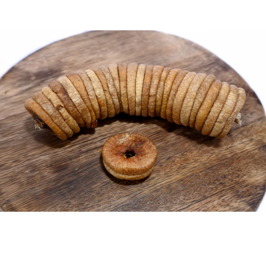 Dry Figs Choice Anjeer spread on a wooden surface, emphasizing their premium look and natural appeal.