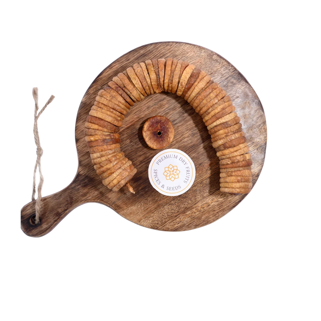 Dry Figs Premium Anjeer arranged neatly on a wooden surface, highlighting their rich brown texture.