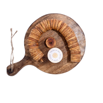Dry Figs Premium Anjeer arranged neatly on a wooden surface, highlighting their rich brown texture.