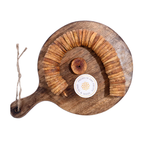 Dry Figs Premium Anjeer arranged neatly on a wooden surface, highlighting their rich brown texture.