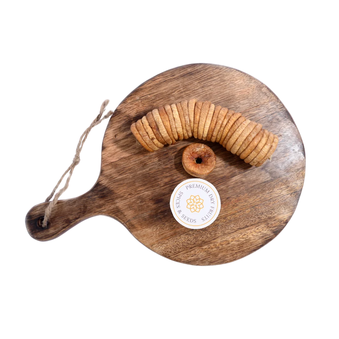 Dry Figs Premium Anjeer spread on a wooden surface, capturing their glossy texture and wholesome appeal.