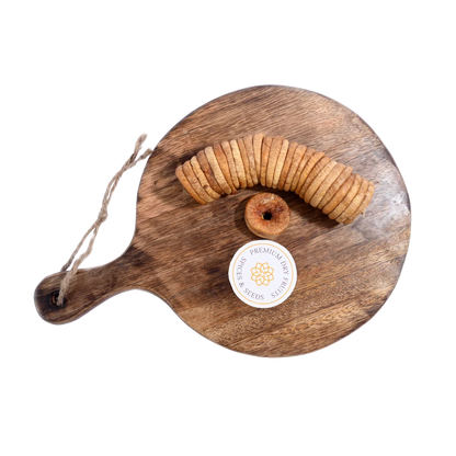 Dry Figs Premium Anjeer spread on a wooden surface, capturing their glossy texture and wholesome appeal.