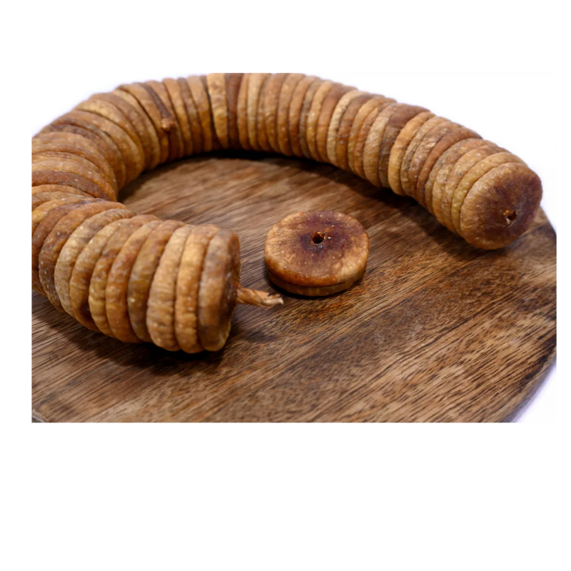 Close-up of Dry Figs Premium Anjeer on a wooden surface, showing natural wrinkles and freshness.