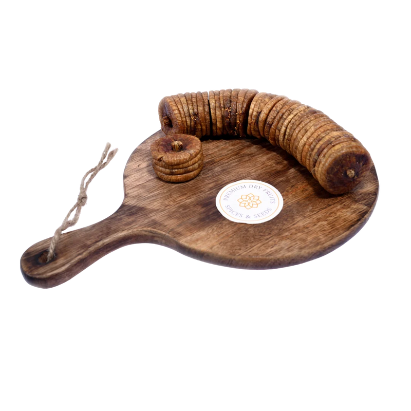 Dry Figs Standard Anjeer placed on a wooden surface, showing their natural brown color and smooth texture.
