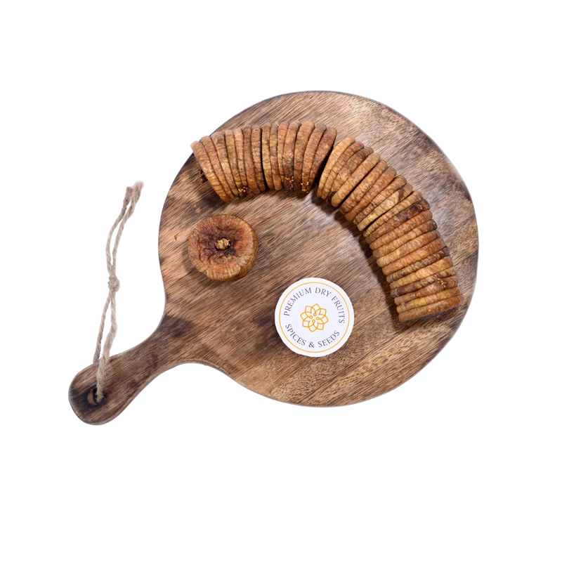 Close-up of Dry Figs Standard Anjeer on a wooden surface, highlighting freshness and natural wrinkles.