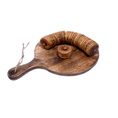 Dry Figs Standard Anjeer neatly arranged on a wooden surface, displaying their round shape and organic look.