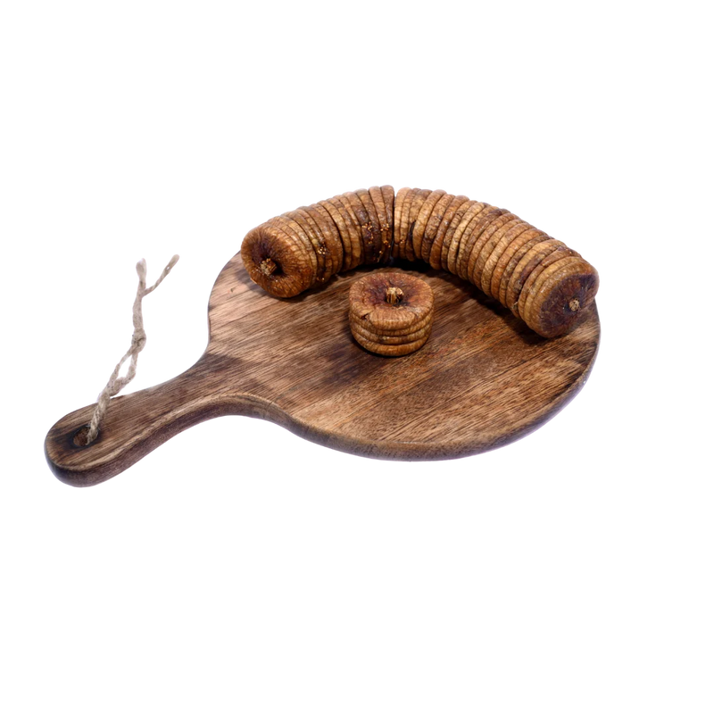 Dry Figs Standard Anjeer neatly arranged on a wooden surface, displaying their round shape and organic look.