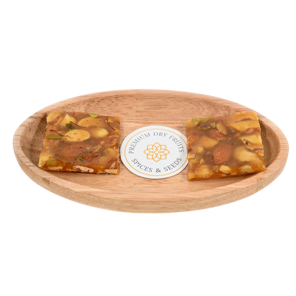 Dry Fruit Chikki on wooden plate delicious Indian brittle made with roasted nuts and jaggery perfect healthy snack for festive season and gifting